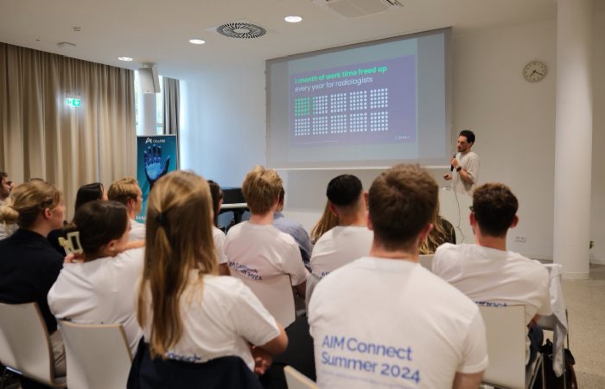 Audience in AIM Connect shirts following a talk at a OneAIM event